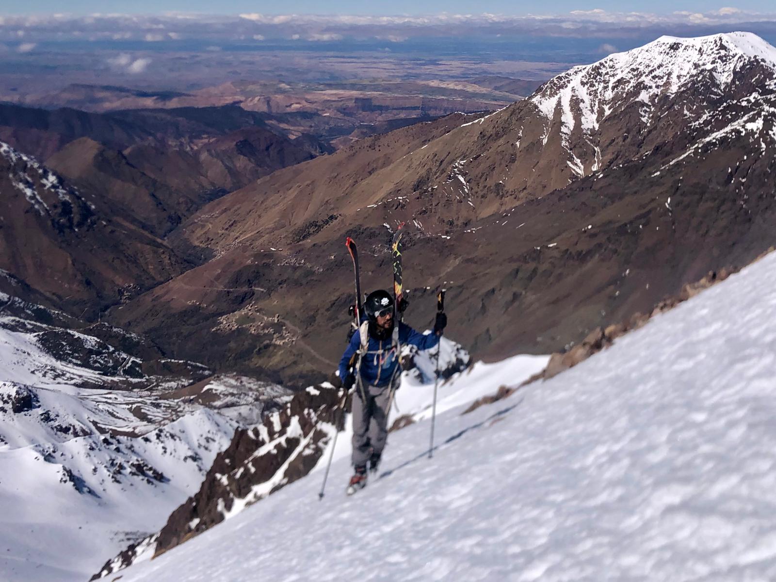 Ski touring expedition from Tachddirt village towards bougnouan Peak in Morocco's snowy High Atlas Mountains.